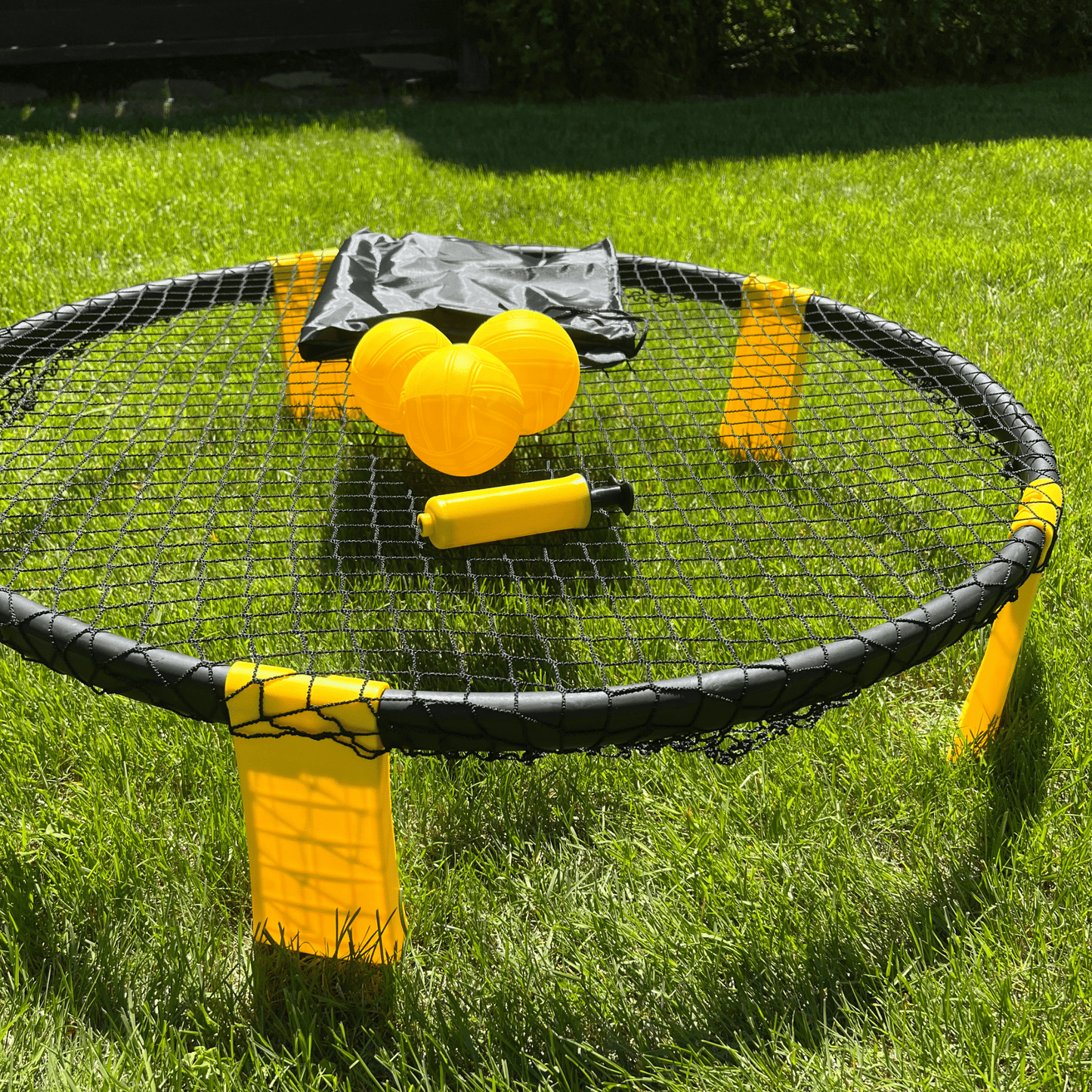 Gros plan balle jaune Roundnet posée sur filet circulaire noir
